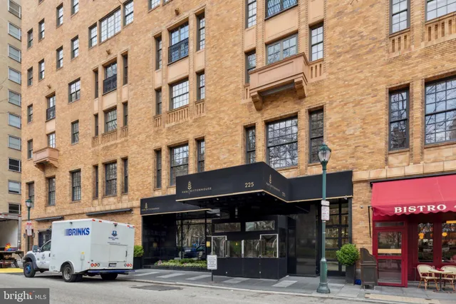 a front view of an apartment building with retail shops