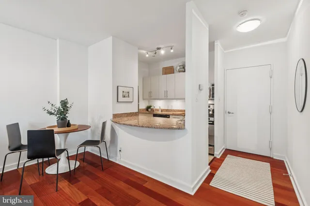 a view of a kitchen and dining room with wooden floor