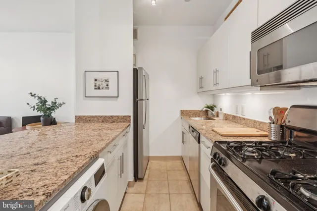 a kitchen with stainless steel appliances granite countertop a stove and a sink