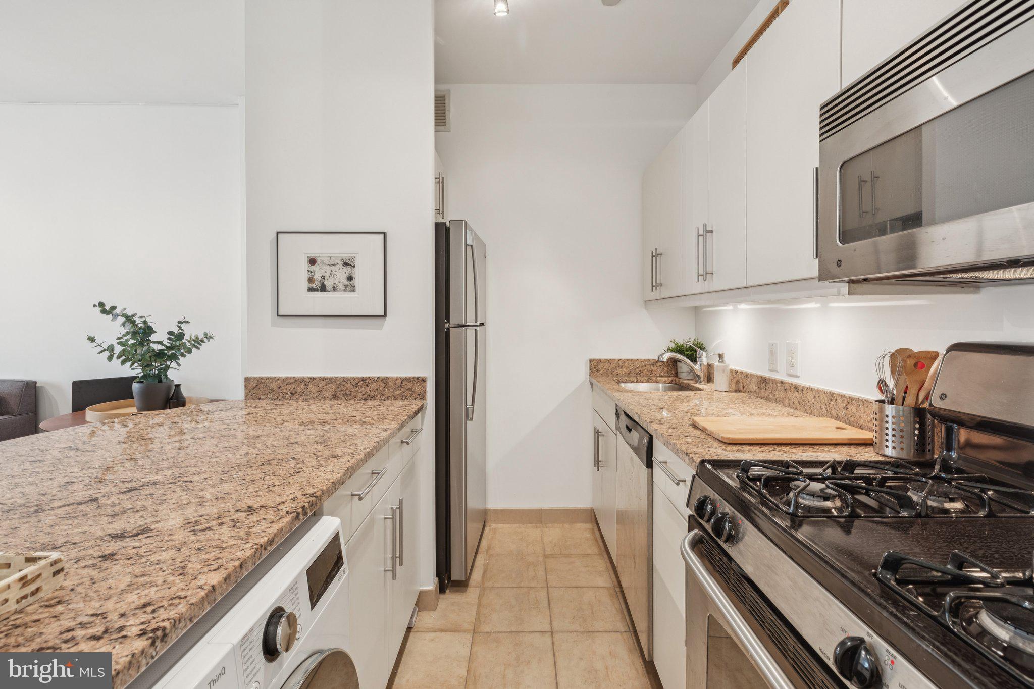 219 South 18th Street, Unit 1605 Philadelphia, PA 19103 - Photo 3 of 15 a kitchen with stainless steel appliances granite countertop a stove and a sink