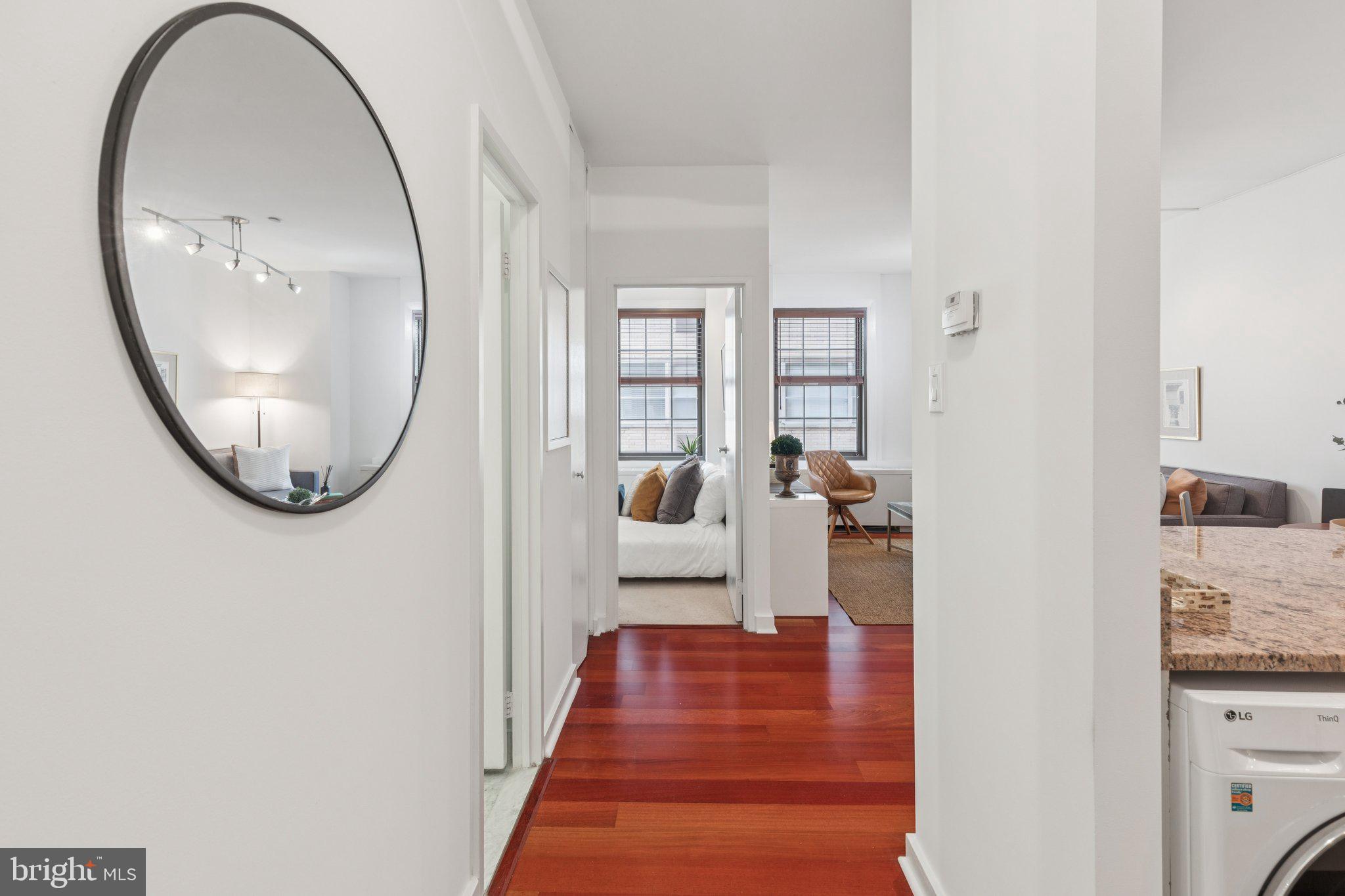219 South 18th Street, Unit 1605 Philadelphia, PA 19103 - Photo 5 of 15 wooden floor in a en suite bathroom with a sink and a mirror