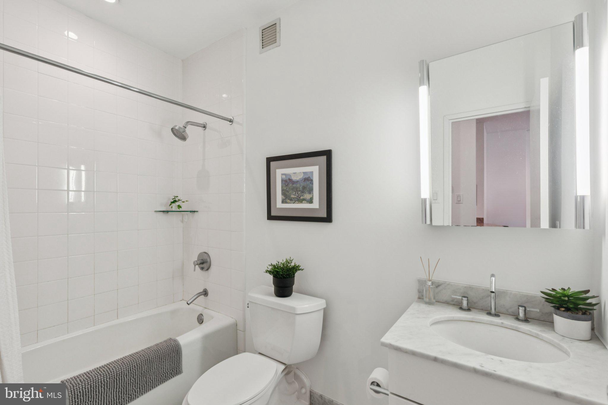 219 South 18th Street, Unit 1605 Philadelphia, PA 19103 - Photo 6 of 15 a bathroom with a sink toilet and shower