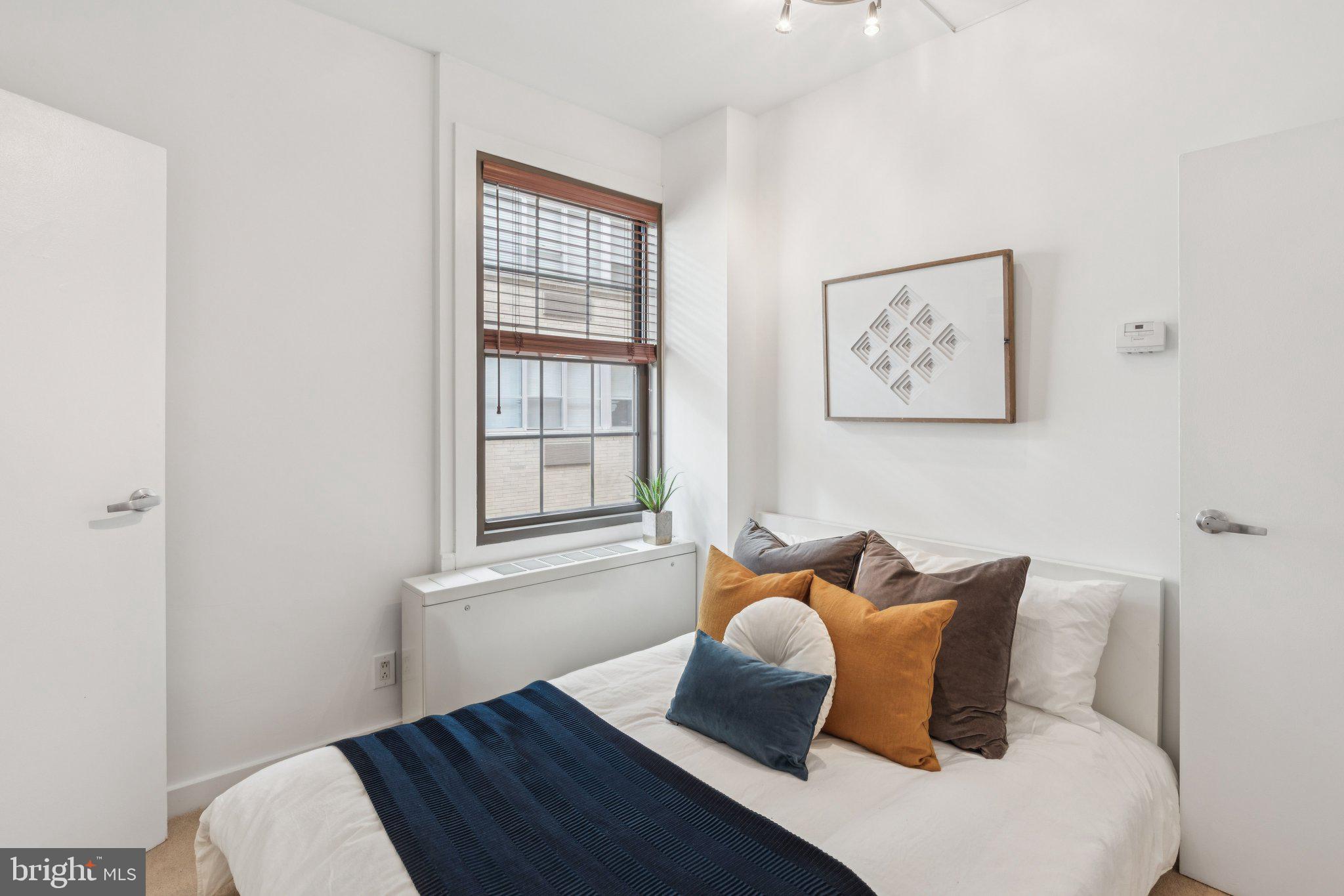 219 South 18th Street, Unit 1605 Philadelphia, PA 19103 - Photo 7 of 15 a bed room with a bed and a window