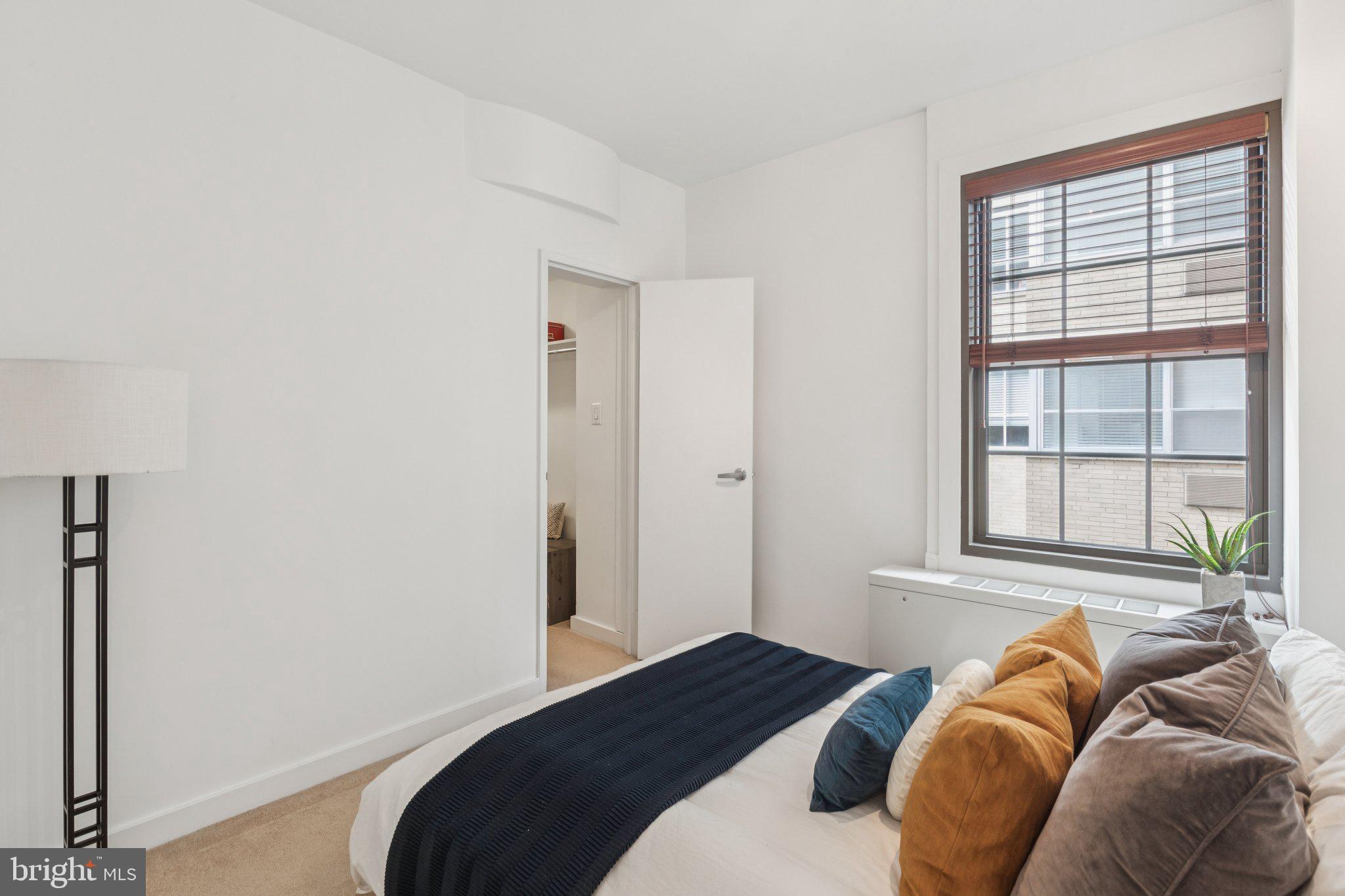 219 South 18th Street, Unit 1605 Philadelphia, PA 19103 - Photo 8 of 15 a bedroom with a bed and a window