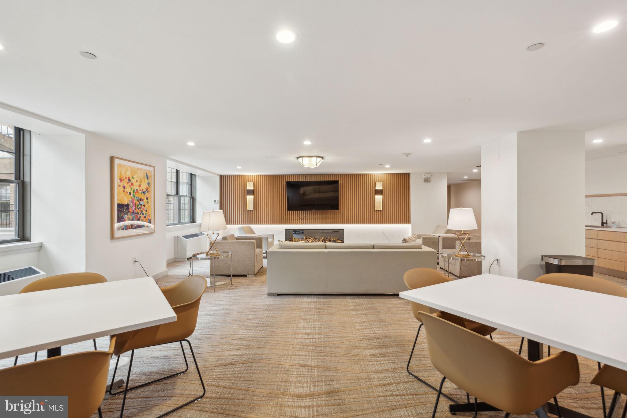 219 South 18th Street, Unit 1605 Philadelphia, PA 19103 - Photo 10 of 15 a large living room with stainless steel appliances furniture a dining table and chairs