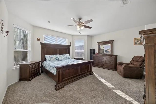 a bedroom with a bed dresser and a window