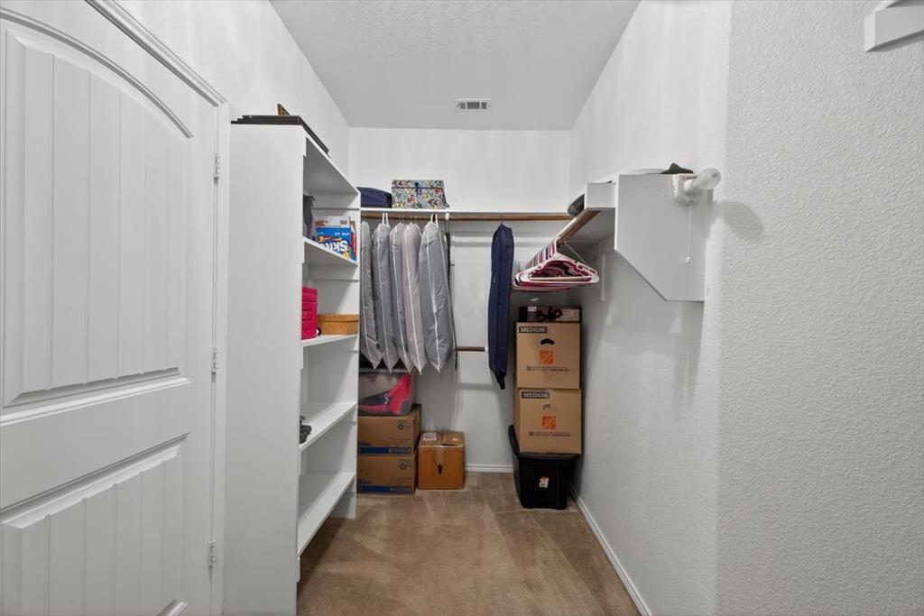 9332 San Tejas Drive Fort Worth, TX 76177 - Photo 18 of 38 a view of walk in closet with clothes