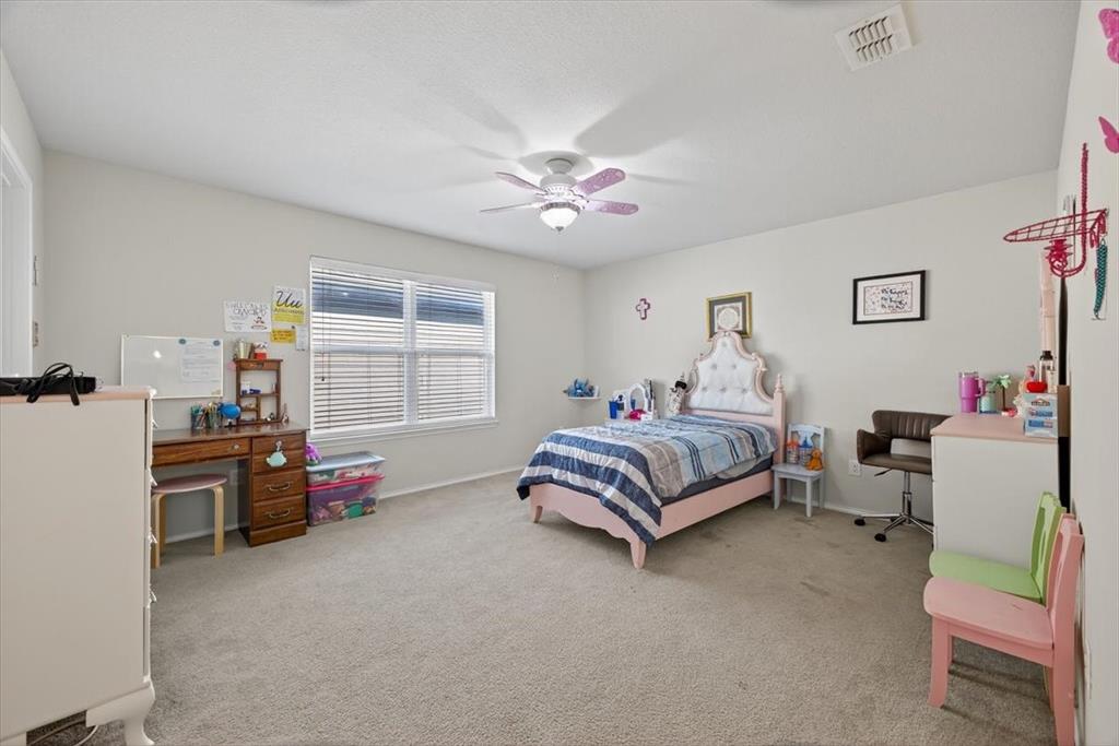 9332 San Tejas Drive Fort Worth, TX 76177 - Photo 21 of 38 a spacious bedroom with a bed and a couch