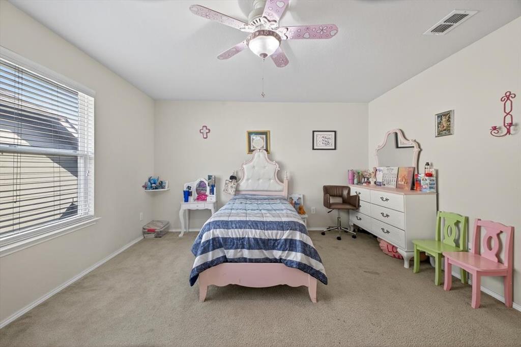 9332 San Tejas Drive Fort Worth, TX 76177 - Photo 22 of 38 a bedroom with furniture and a chandelier