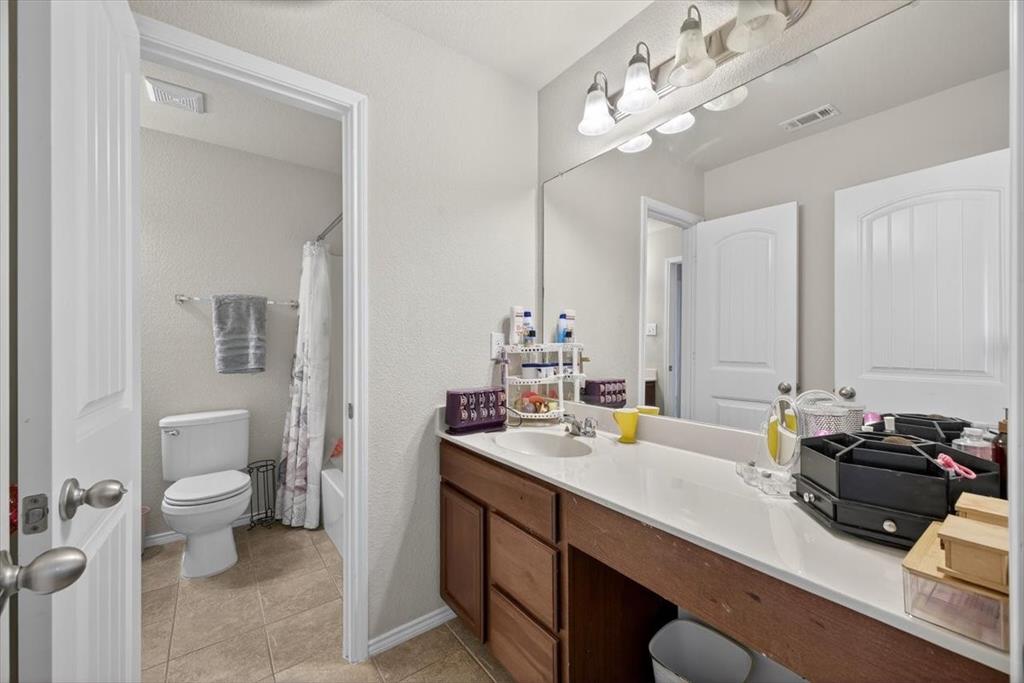 9332 San Tejas Drive Fort Worth, TX 76177 - Photo 23 of 38 a bathroom with a sink double vanity and a mirror