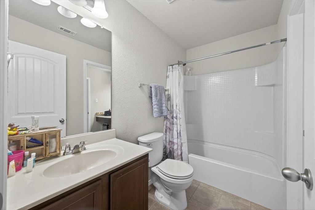9332 San Tejas Drive Fort Worth, TX 76177 - Photo 24 of 38 a bathroom with a sink a toilet and shower