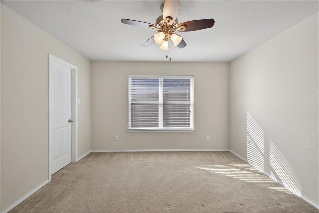 9332 San Tejas Drive Fort Worth, TX 76177 - Photo 28 of 38 an empty room with a chandelier fan and windows