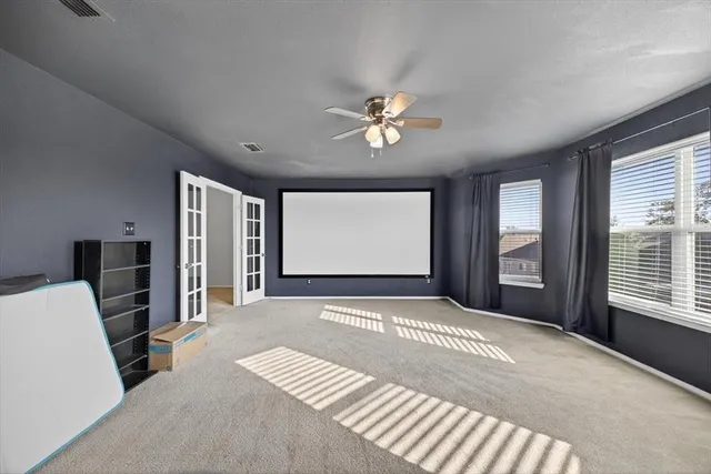 a bedroom with a bed desk and chair