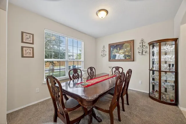 a view of a dining room with furniture and window