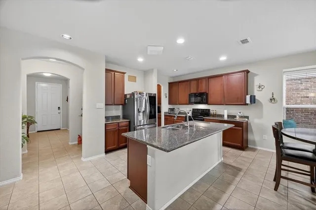 a dining room with furniture a window and kitchen view