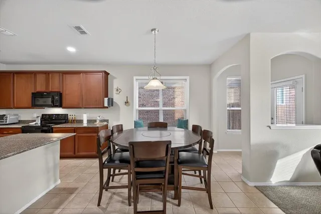 a dining room with furniture and entryway