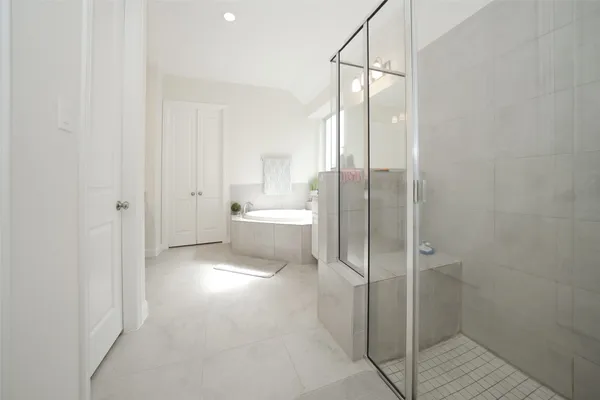 a bathroom with a bathtub and a shower