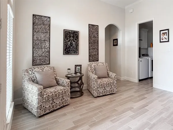 a living room with furniture and wooden floor