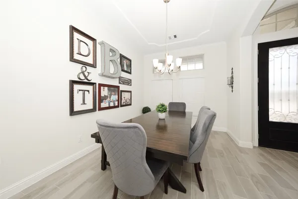 a view of a dining room with furniture and chandelier