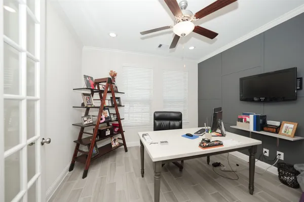 a view of a workspace with furniture and a flat screen tv
