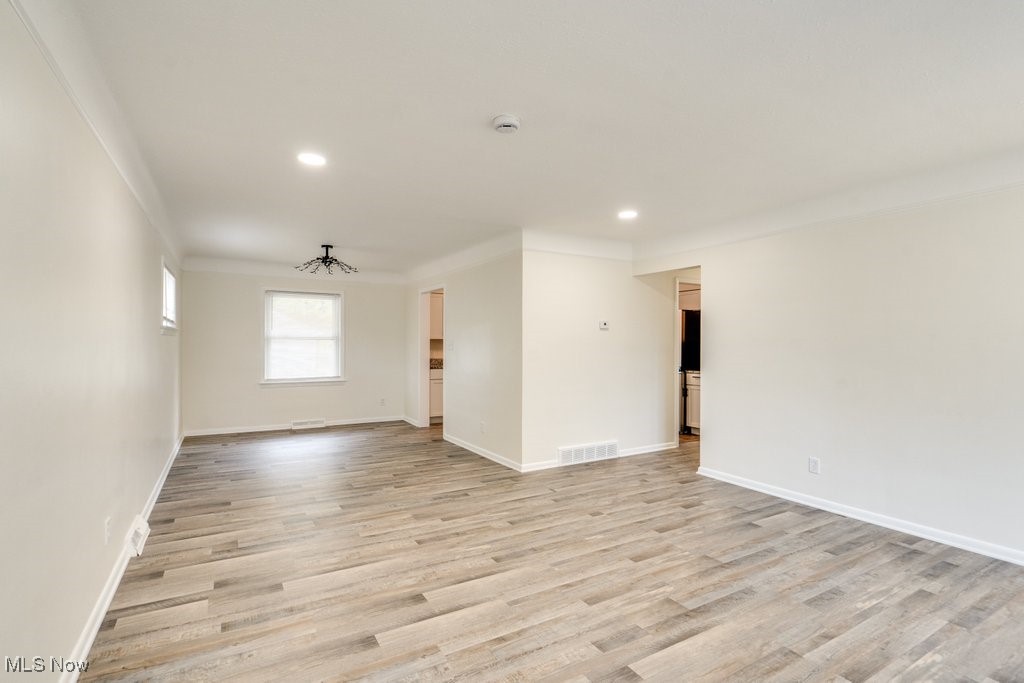 6961 Maplewood Road Parma Heights, OH 44130 - Photo 7 of 22 Unfurnished room with light hardwood / wood-style flooring and ornamental molding
