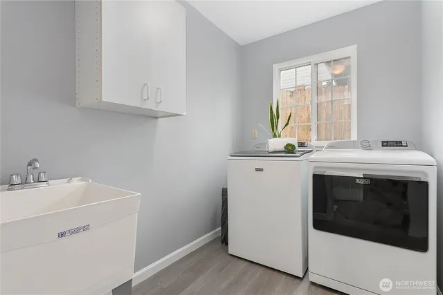 a utility room with a sink washer and dryer