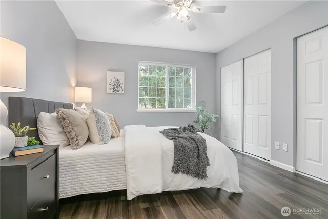 a bedroom with a bed and wooden floor
