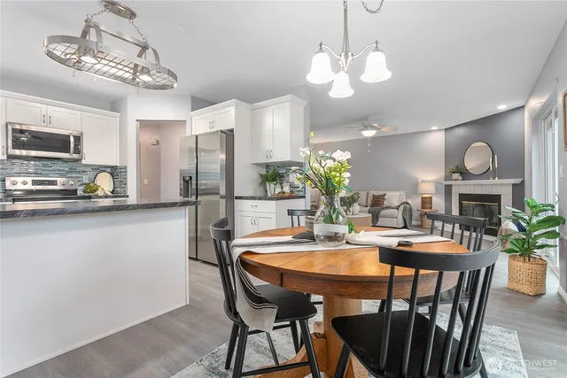 a view of a dining room with furniture and a chandelier