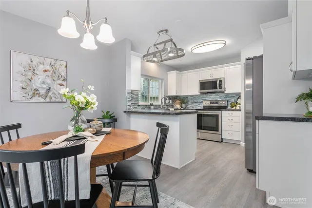 a view of kitchen with cabinets table and chairs