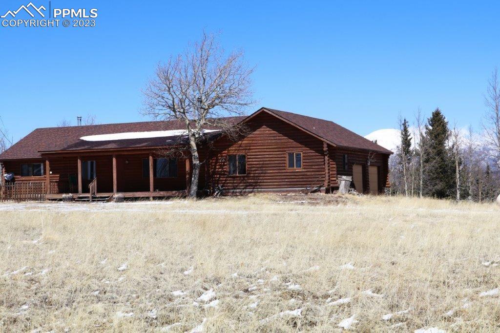 1327 County Road 863 Victor, CO 80860 - Photo 1 of 29 a front view of a house with a yard covered in snow