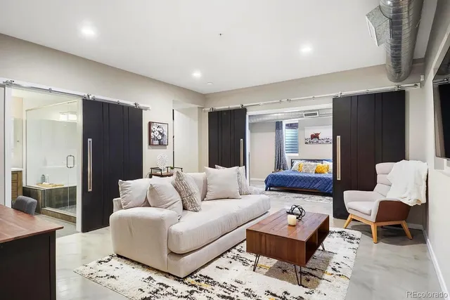 a living room with furniture and a rug