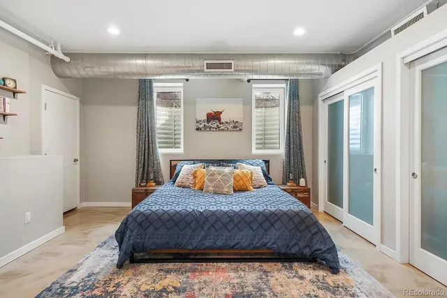 a bedroom with a large bed and a window