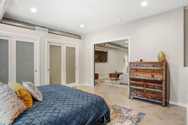 a bedroom with a bed and a television