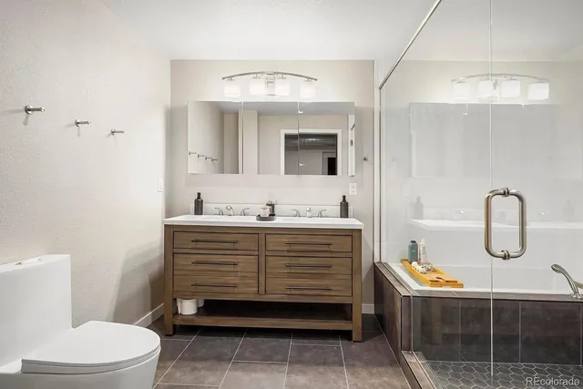 a bathroom with a sink a toilet and mirror