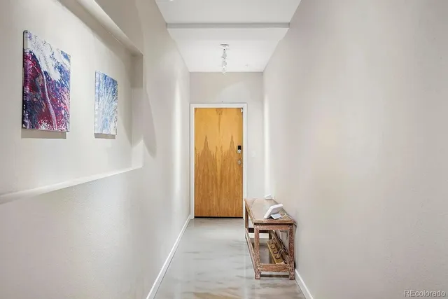a view of a hallway with paintings on the wall