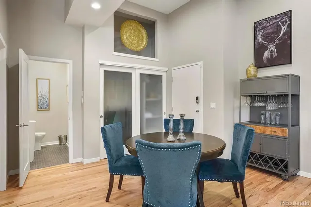 a dining room with furniture and wooden floor