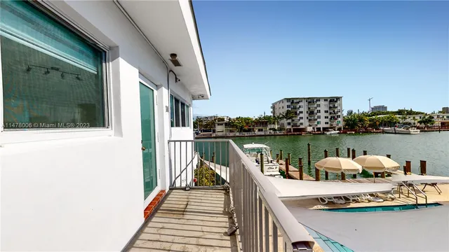 a kitchen with granite countertop white cabinets and stainless steel appliances