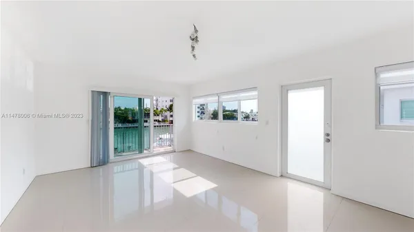 a view of a living room with furniture and window