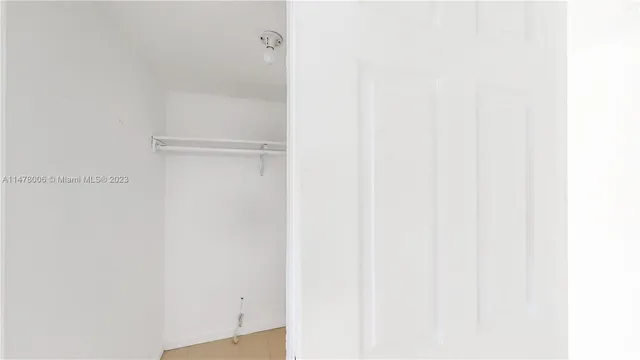 a large kitchen with a large counter top appliances and cabinets
