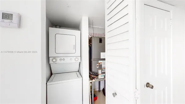 a kitchen with stainless steel appliances granite countertop a sink and a refrigerator