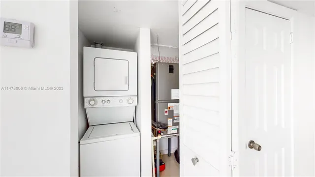 a kitchen with stainless steel appliances granite countertop a sink and a refrigerator