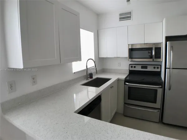 a view of a livingroom with furniture and floor to ceiling window