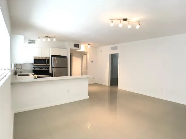 a dining room with furniture a chandelier and window