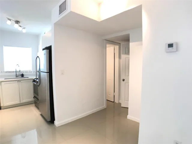a kitchen with a sink and a stove top oven