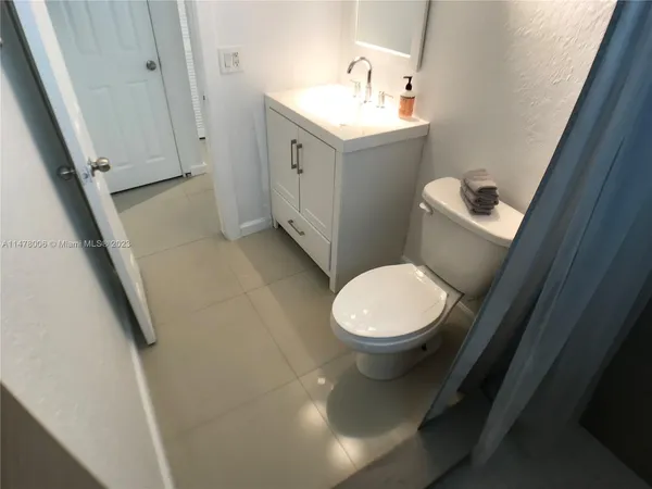a view of a livingroom with wooden floor and a hallway