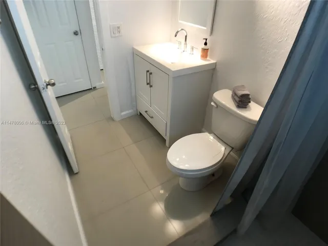 a view of a livingroom with wooden floor and a hallway