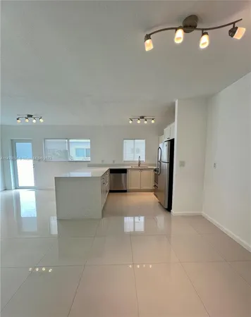 a living room with furniture and a large mirror