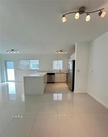 a living room with furniture and a large mirror