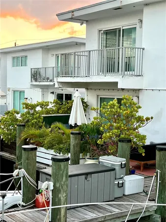 a patio with a table and chairs under an umbrella