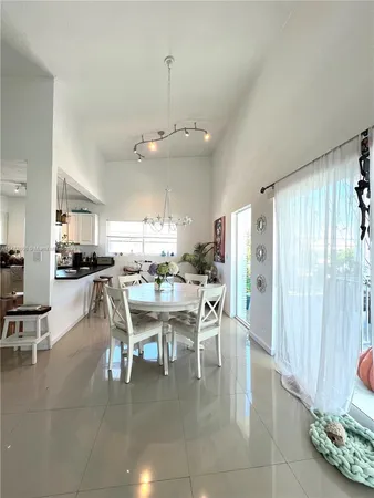 a balcony of a house with wooden floor and outdoor seating
